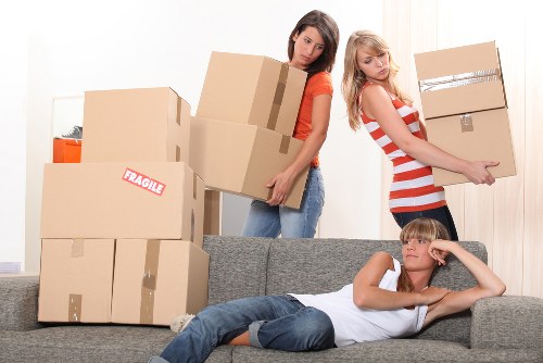 Experienced movers in Lewisham organizing boxes and furniture for a home relocation